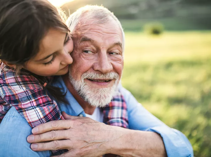 small child embracing older man
