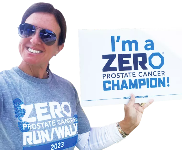 Woman with sunglasses holding a I'm a ZERO Champion sign