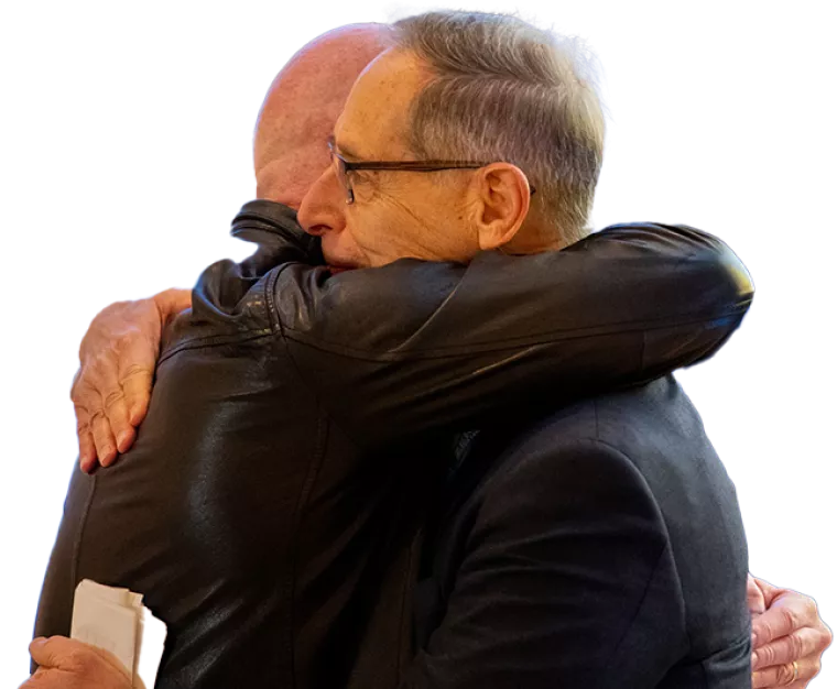 Two men hugging
