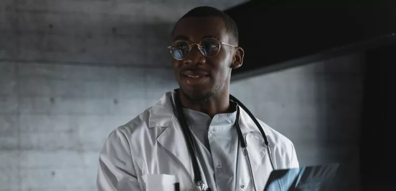 Black Doctor holding up a scan