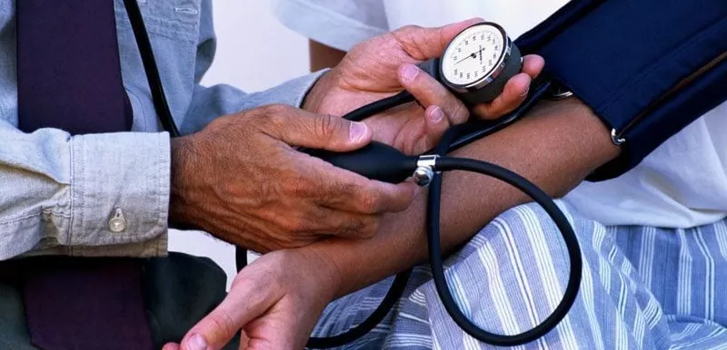 Patient getting their blood pressure read by a doctor