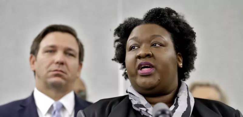 Florida Health News Lead By Proud Black Woman While DeSantis Stands In Background