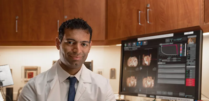 Researcher proud of his advancements on his computer