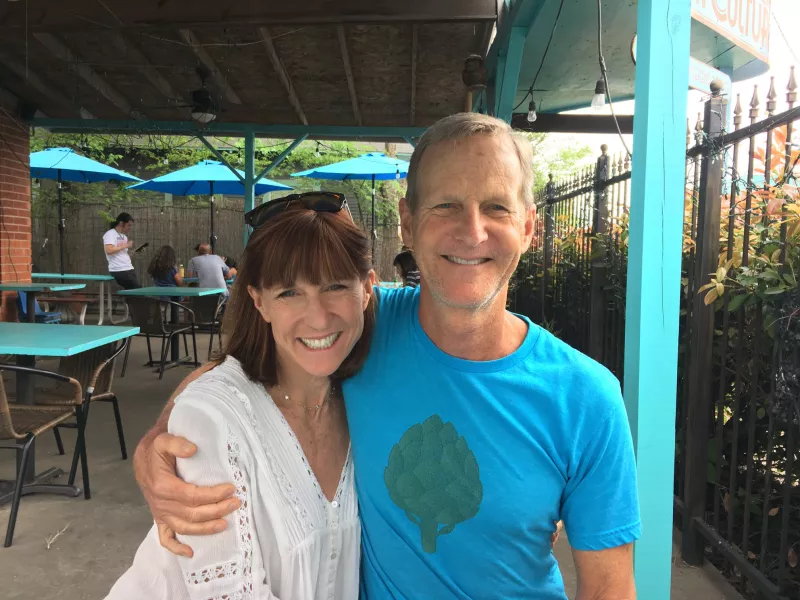 Bruce and his wife Mindy happy on a back porch of a restaurant 