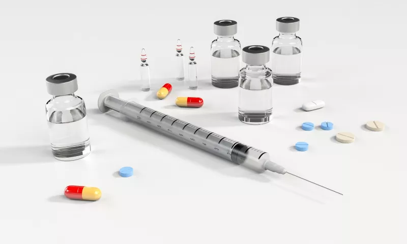 A selection of sterile medical supplies and generic pills on a white background