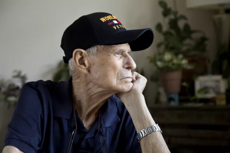 White elderly man with a veteran's hat