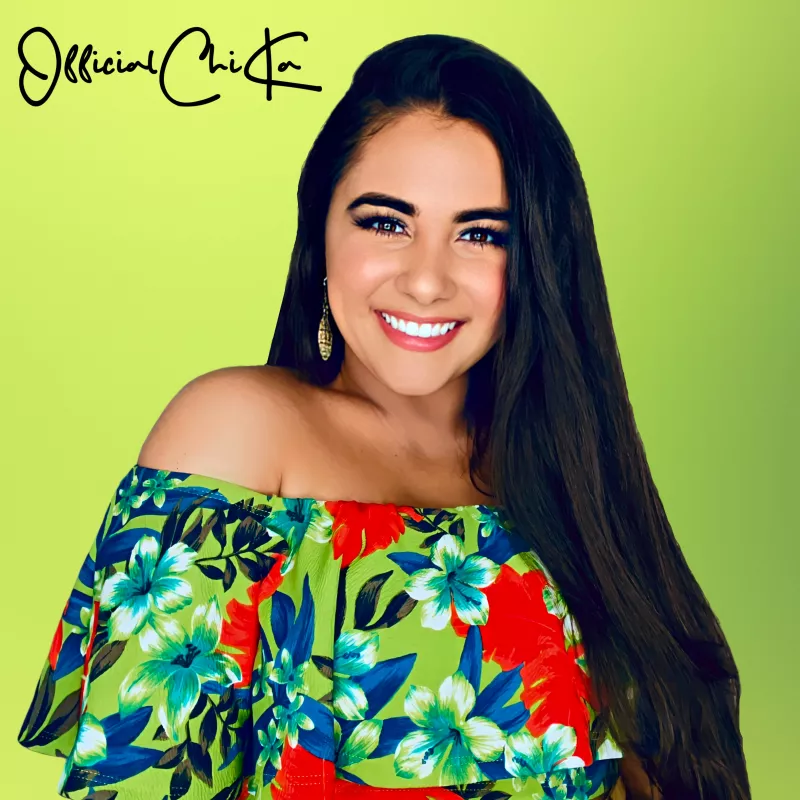 Headshot of a woman with dark hearwearing floral off shoulder dress in front of a lime green background