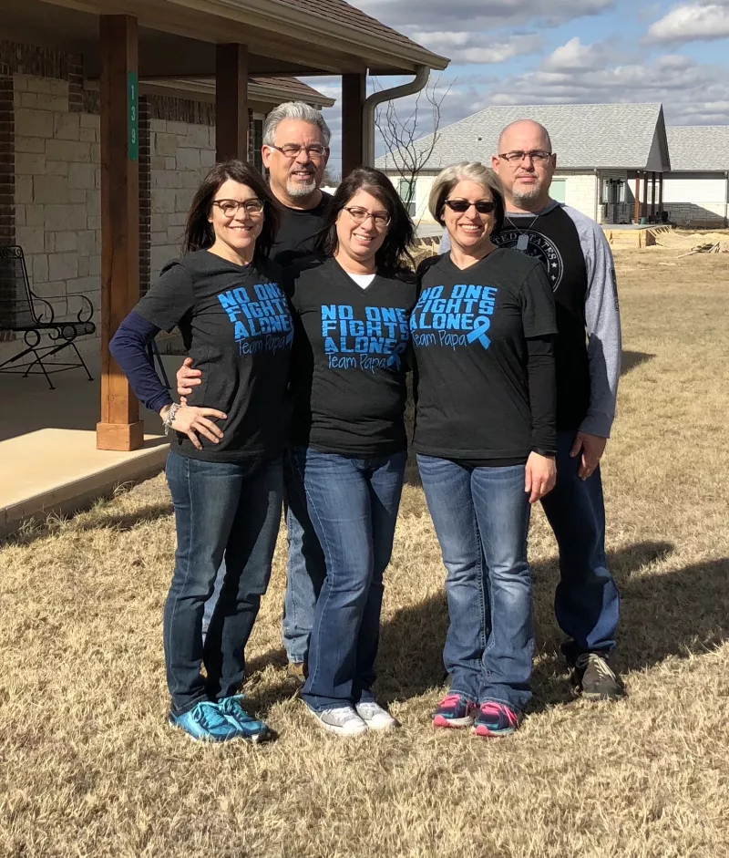 Family photo wearing matching shirts saying no one fights alone