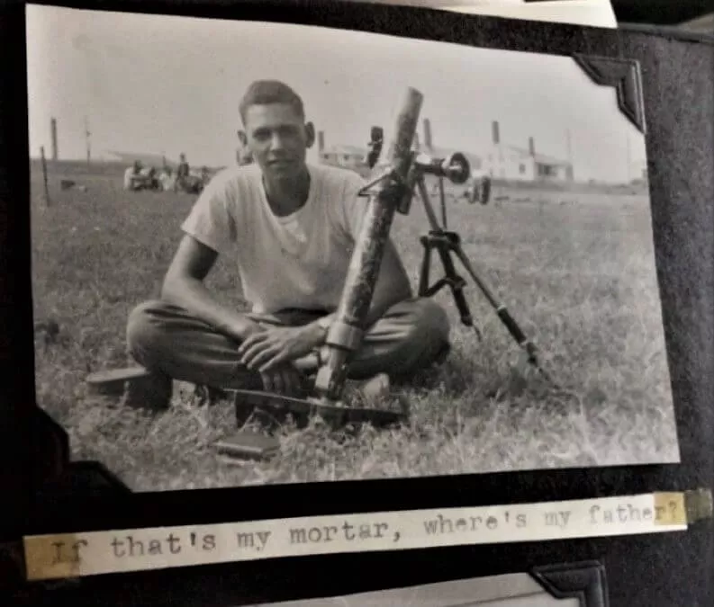 Picture in a family album of Jack Berger with a mortar launcher that says "If that's my Mortar where's my Father?"