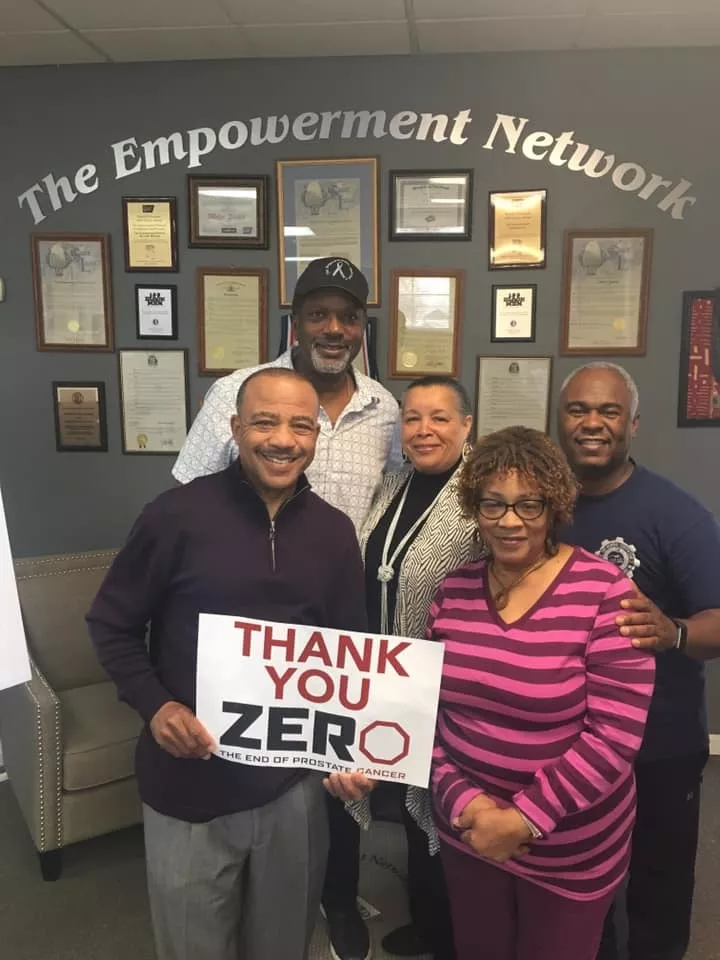 The Empowerment Network and holding up a sign saying thank you ZERO