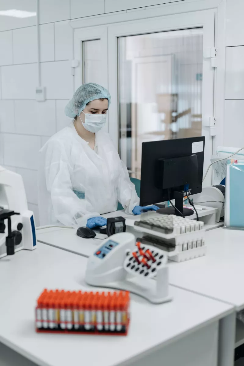 Woman Working in a Laboratory Wearing a Personal Protective Equipment