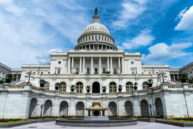 Large united states capital building from the on a very blue and partly cloudy sky day