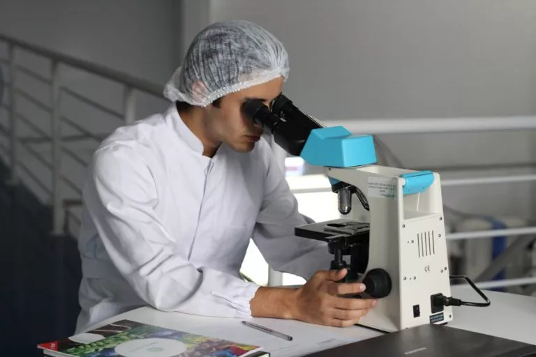 researcher using microscope