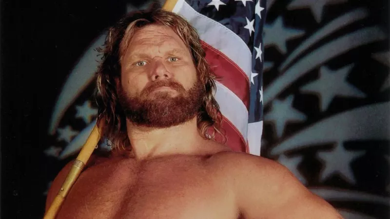 Jim Hacksaw Duggan holding an American flag