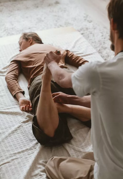 Man getting his legs and pelvic floor stretched out