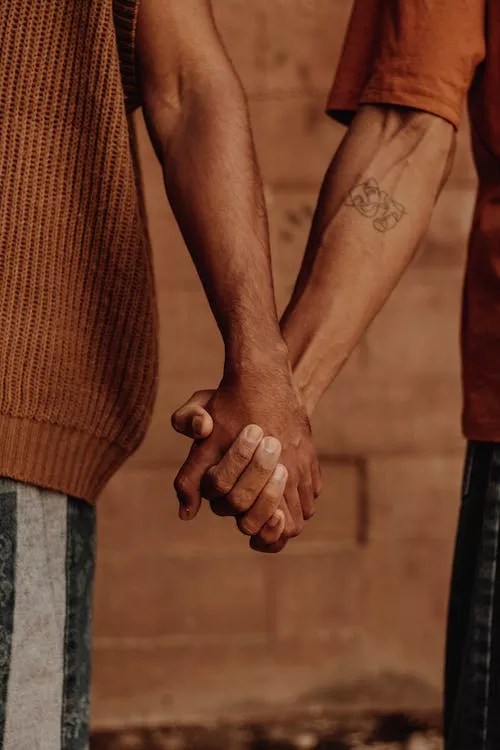 Two men holding hands