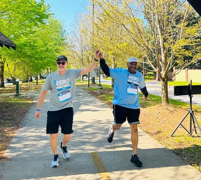 Two runners high-five at the 2023 Atlanta Run/Walk