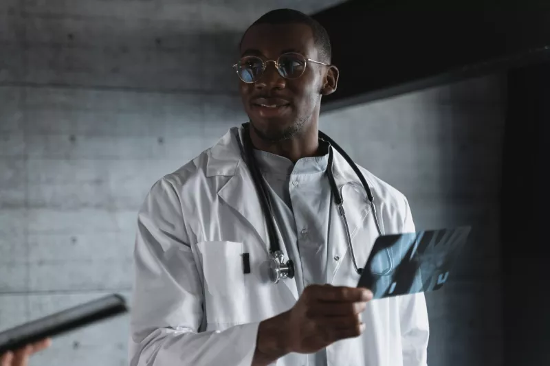 African American doctor looking at X-rays