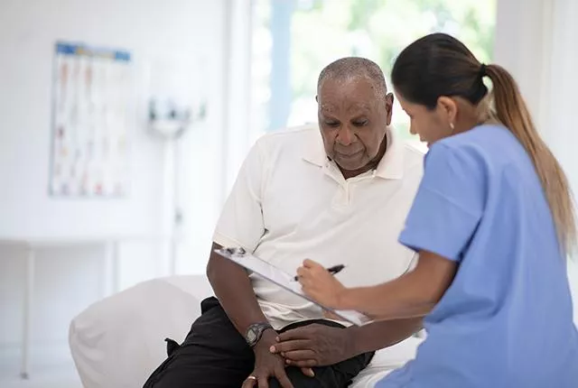 African American male patient talking to his doctor