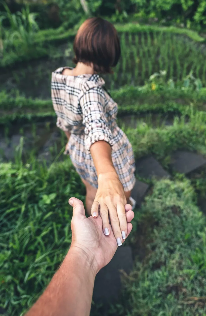 Couple holding hands in a field