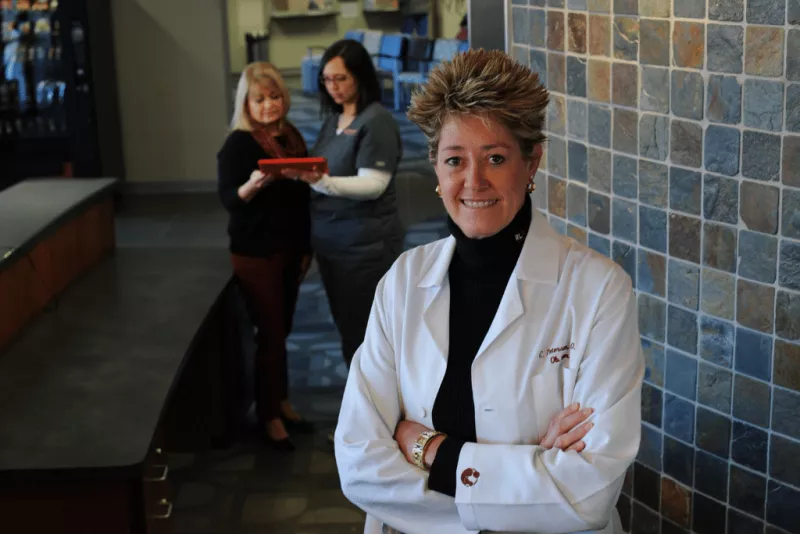 Female doctor in front of two other women discussing something