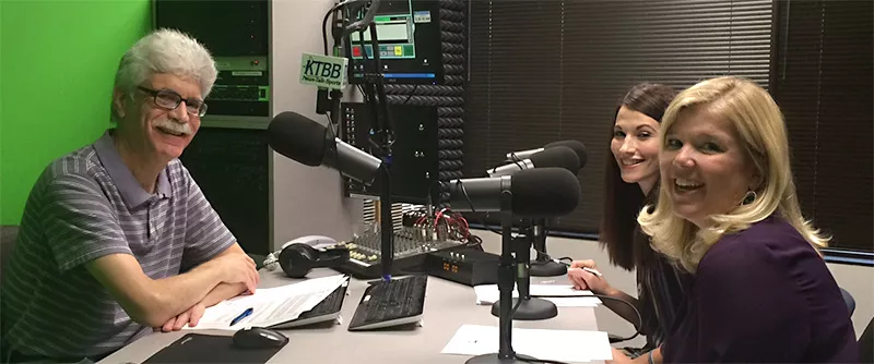 Male radio host with two female guest speakers