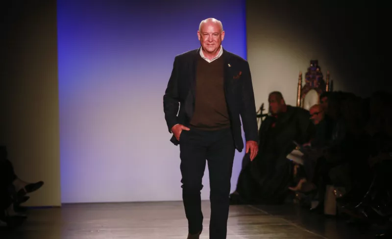 Middle-aged man walking down a runway