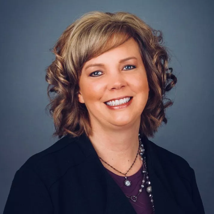 Woman with highlights smiling at the camera