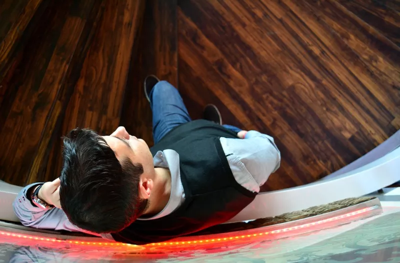 Young man leaning against a wall and waiting