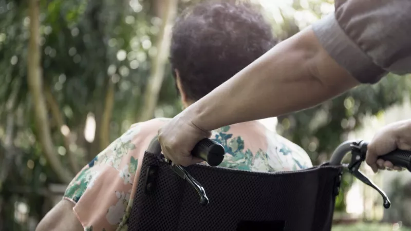 Woman in a wheelchair shot from the back