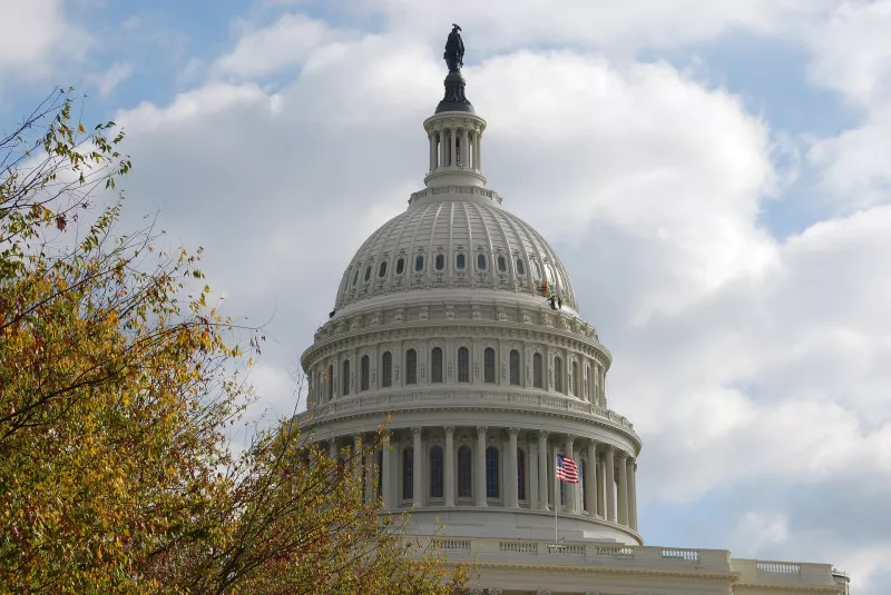 The dome of the Capitol against a sky with clouds