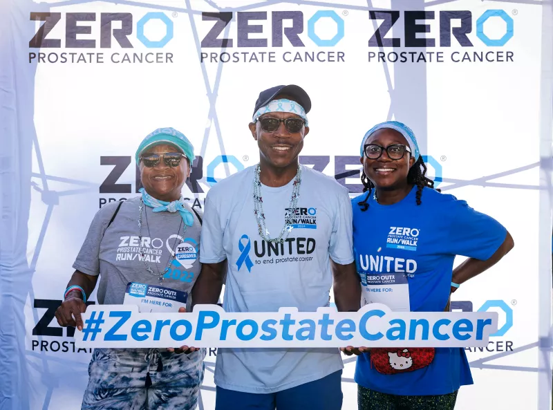 Family of three holding sign