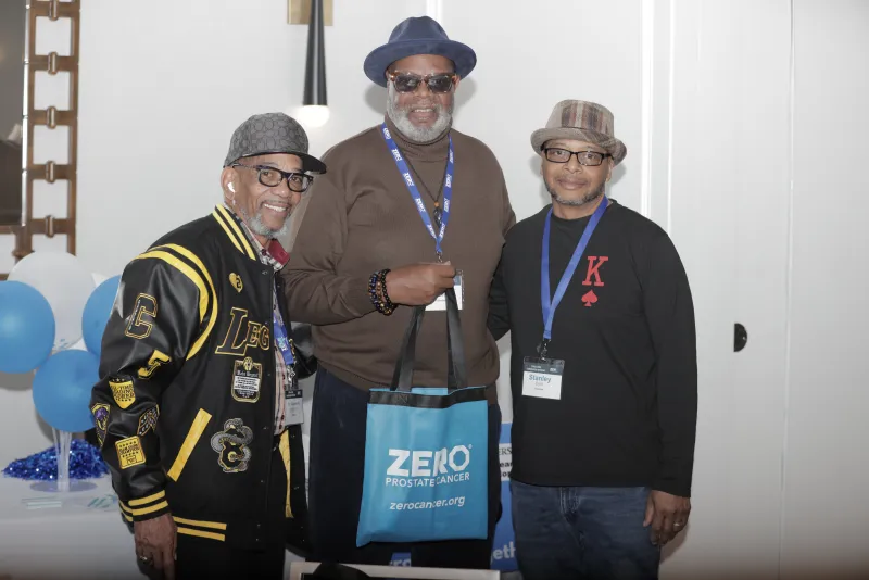 Three people smiling and standing shoulder to shoulder