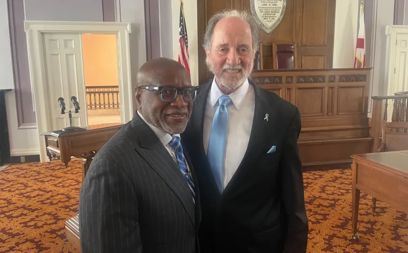Two men smiling