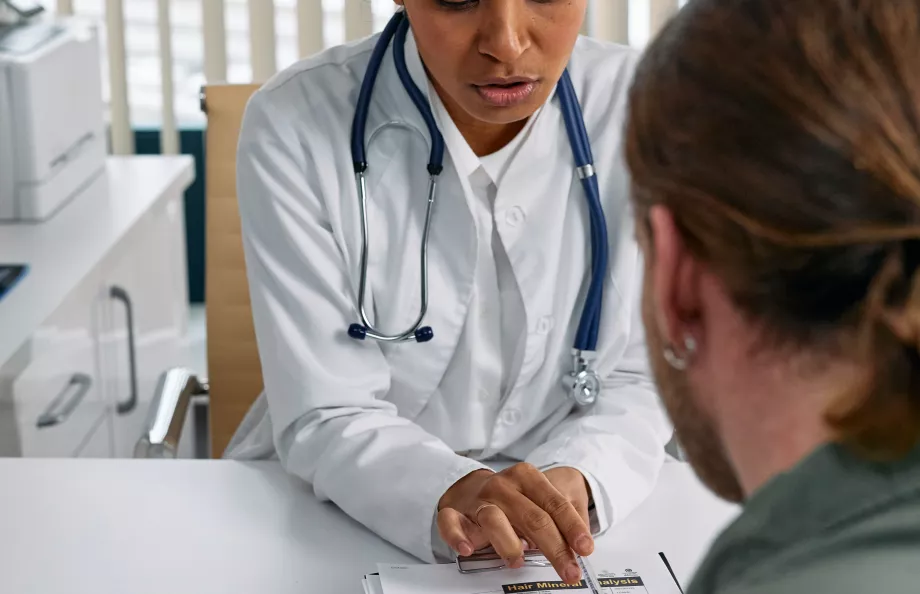 White female doctor reviewing patient's file with a male patient