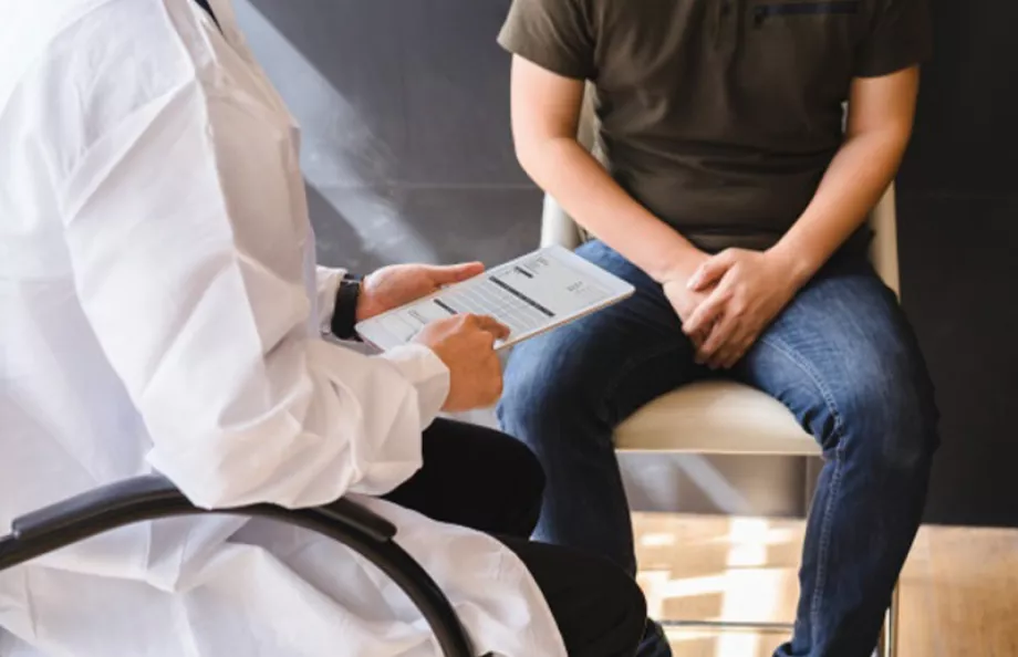 Man sitting in a chair across from doctor