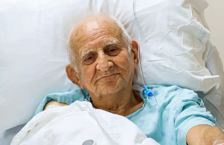 A senior man laying in a hospital bed