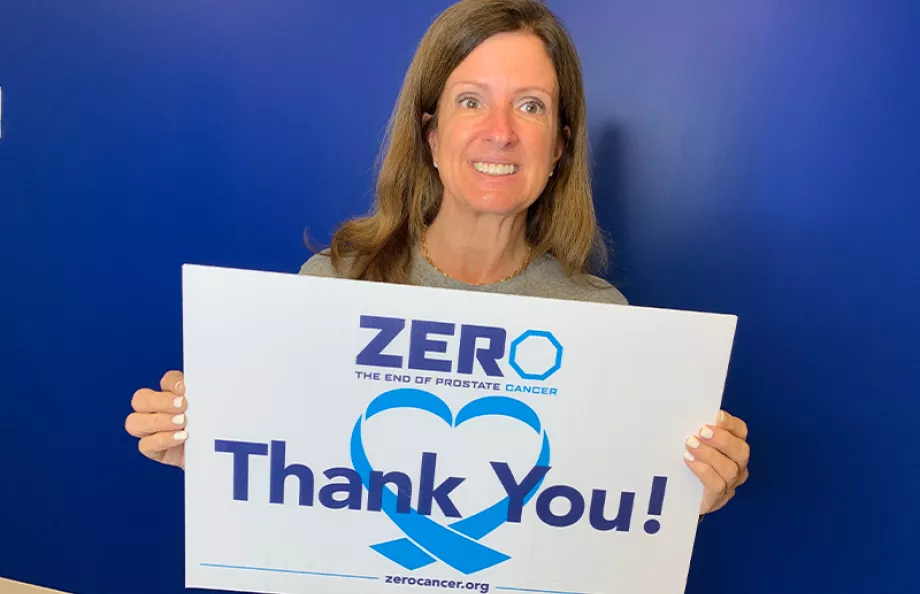ZERO Board Member Sandy Maxey holding a thank you sign