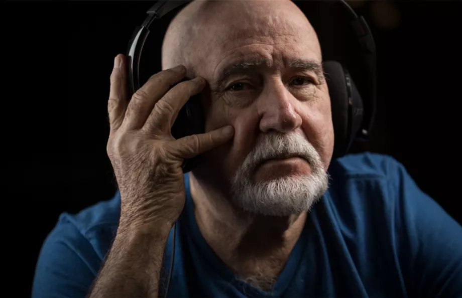Senior man listening to headphones