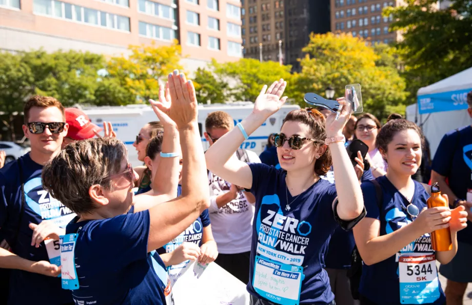 A group of people doing high-fives 