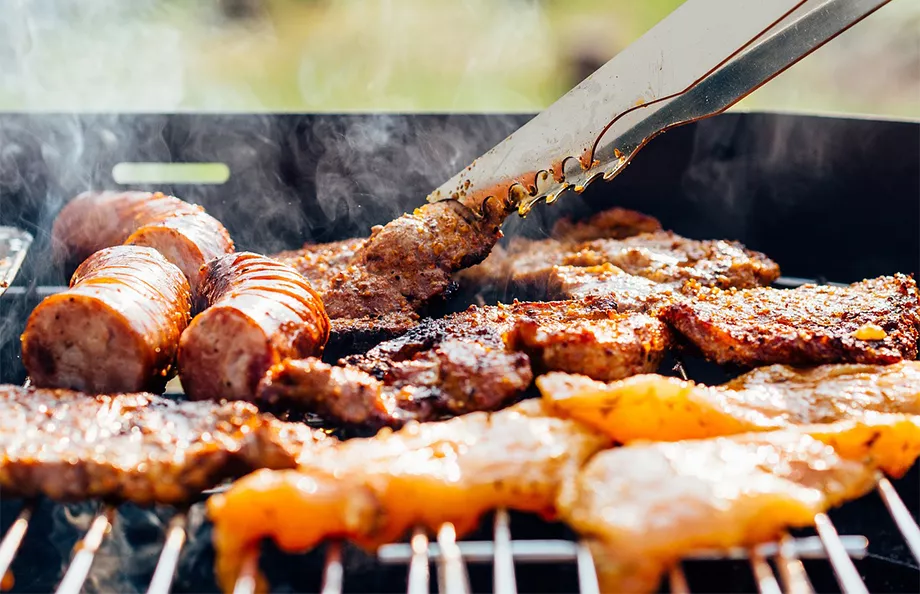 A close up of a grill with different meats