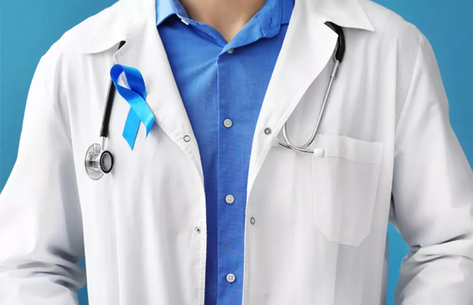 A doctor wearing a blue ribbon