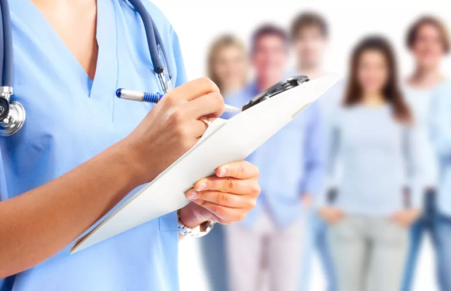 Medical professional holding a chart in front of a group of people