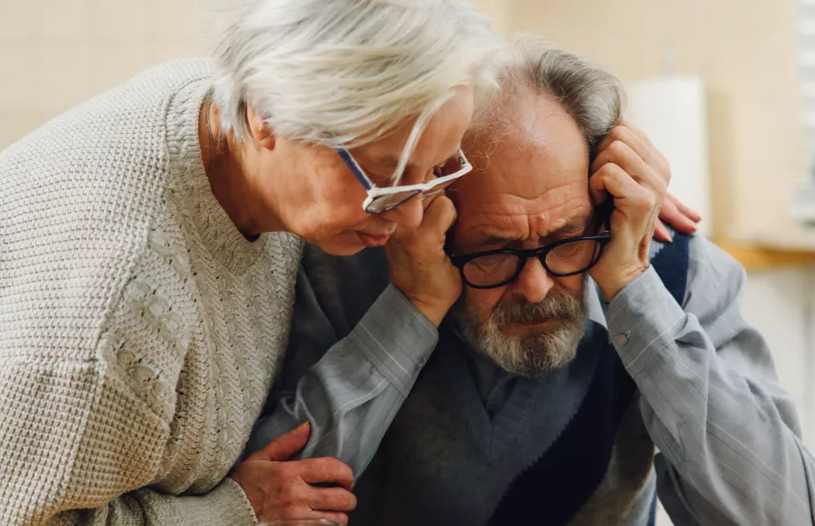 Heterosexual couple looking at documents looking distressed