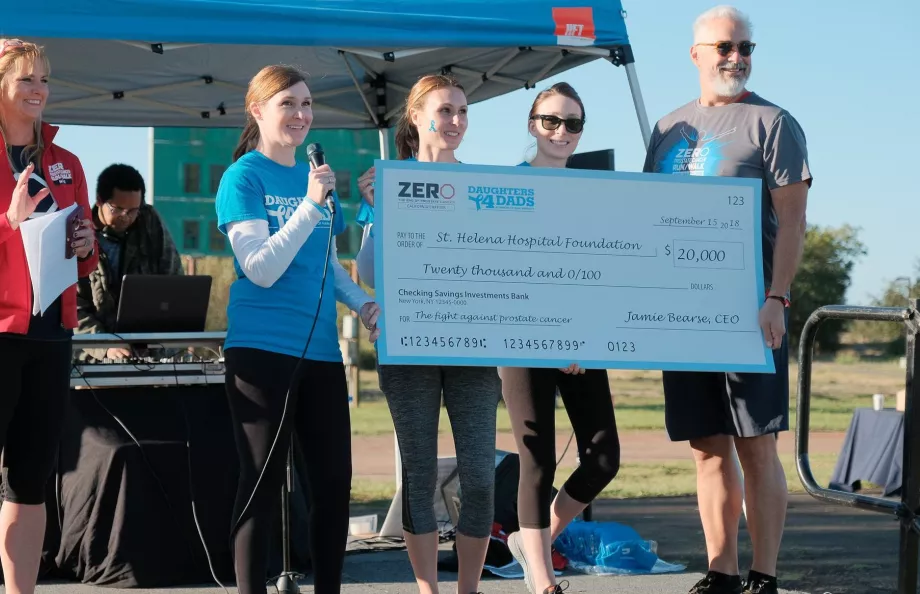 Group of people holding a massive check