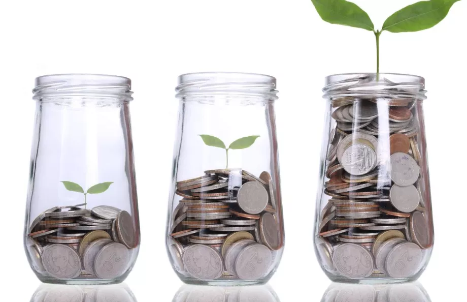 Three glass jars with metal coins in them