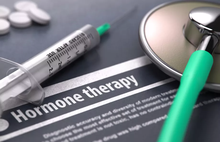 Stethoscope, syringe and a flyer with a title Hormone Therapy