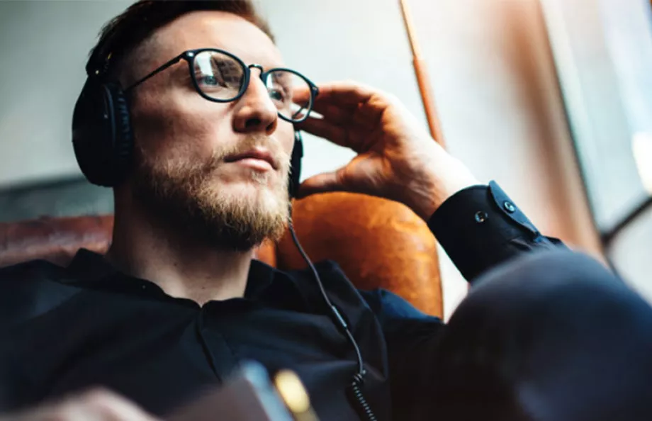 Man sitting in chair with headphones on