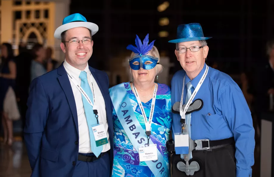 Three people dressed up in blue and wearing hats