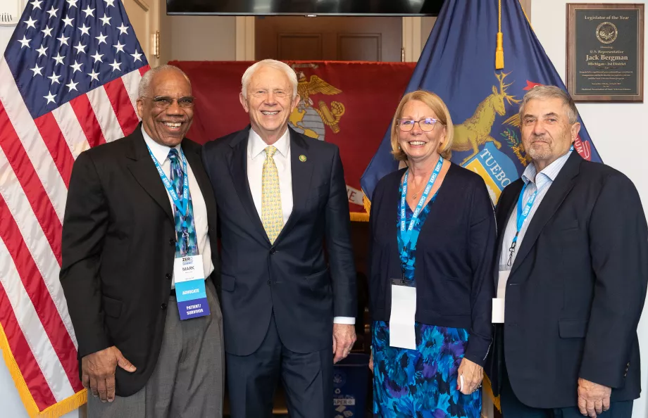 Group of people standing in front of the US flag